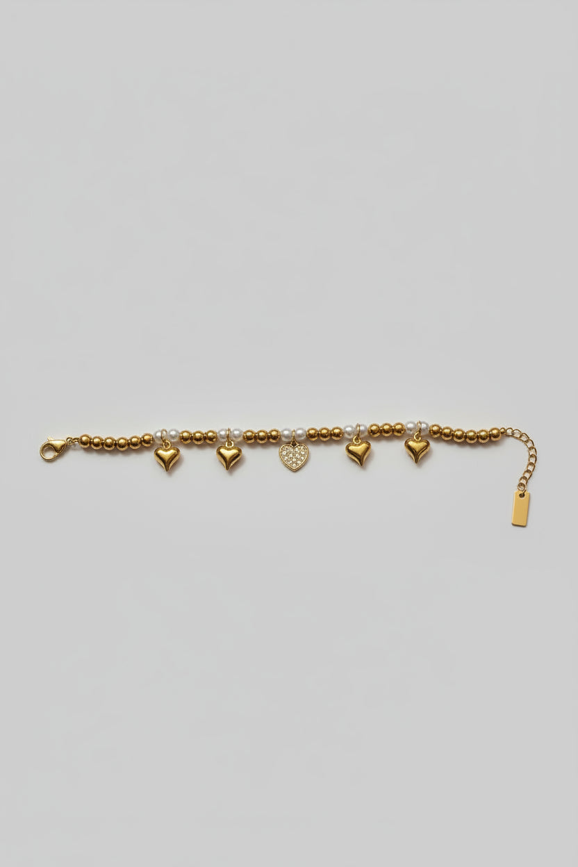 Bracciale di Sfere in Acciaio Dorato con Perline Bianche e Charm Cuori