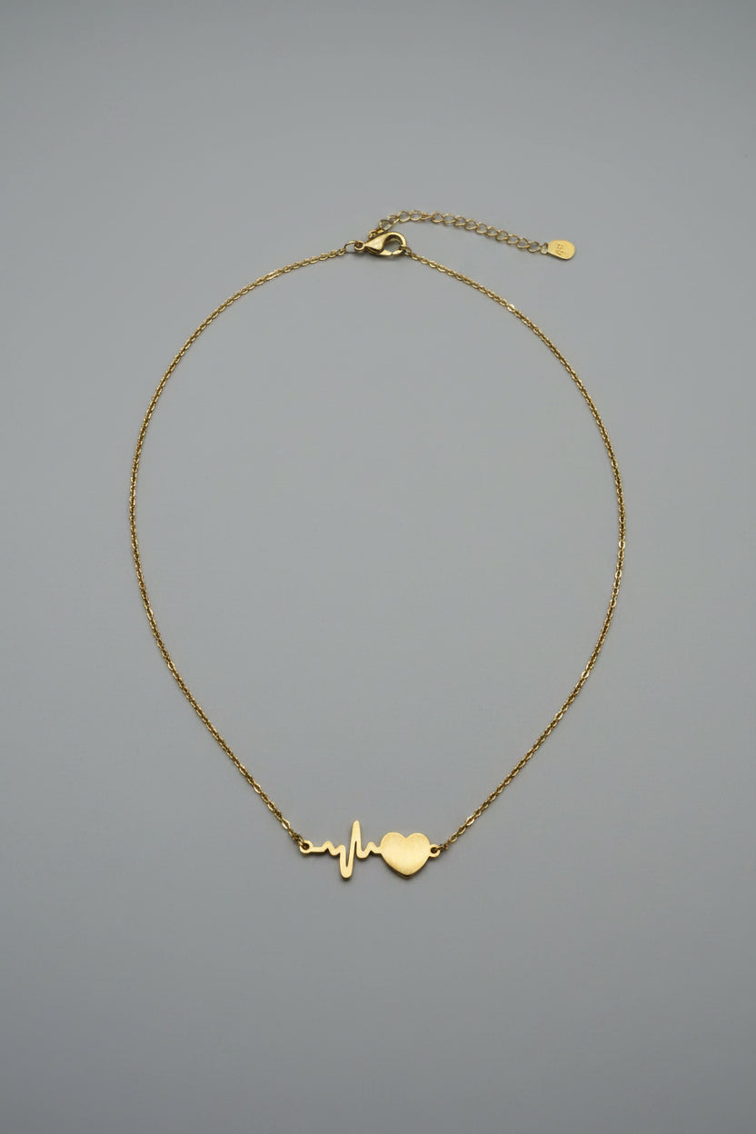 Collana Pulsus con pendente battito cardiaco e cuore in acciaio dorato