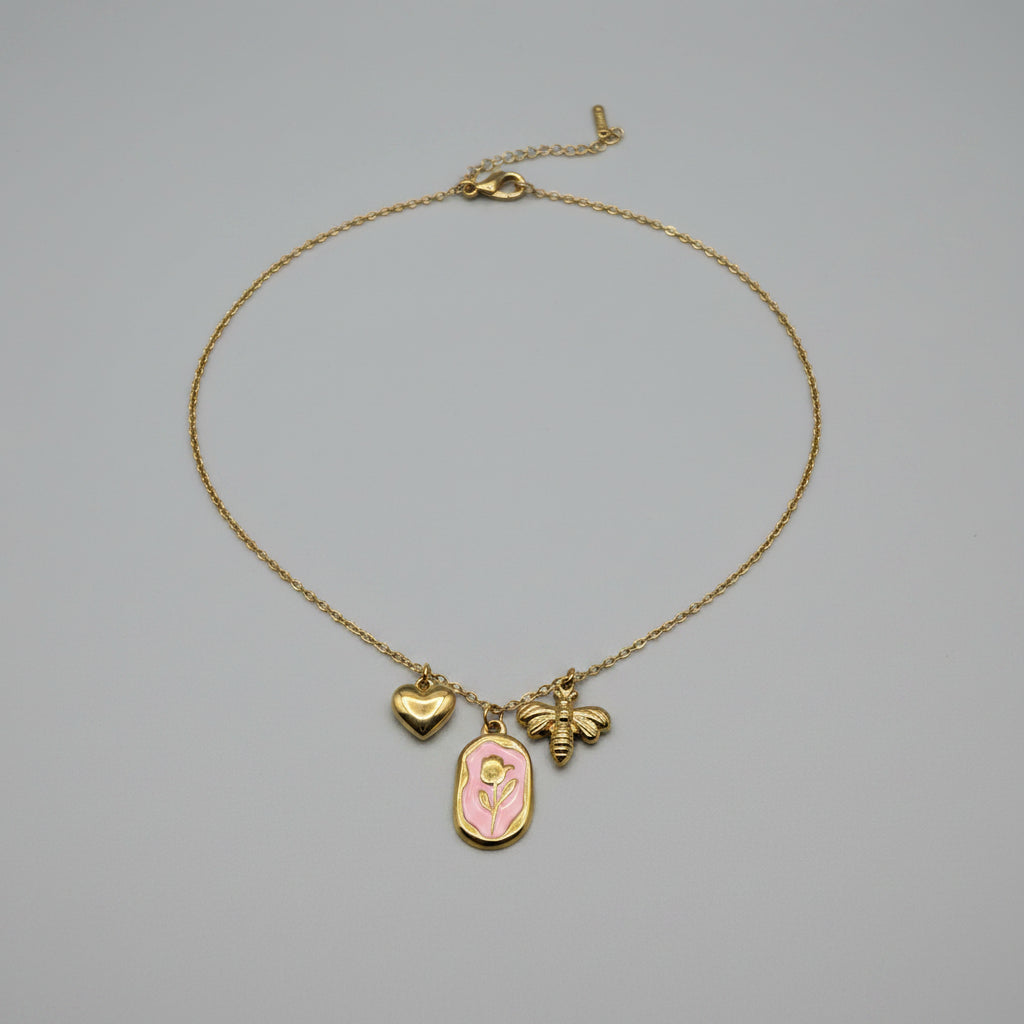 Collana Flora Aurea Rosa con tre charm dorati: cuore, piastra con rosa smaltata rosa e ape