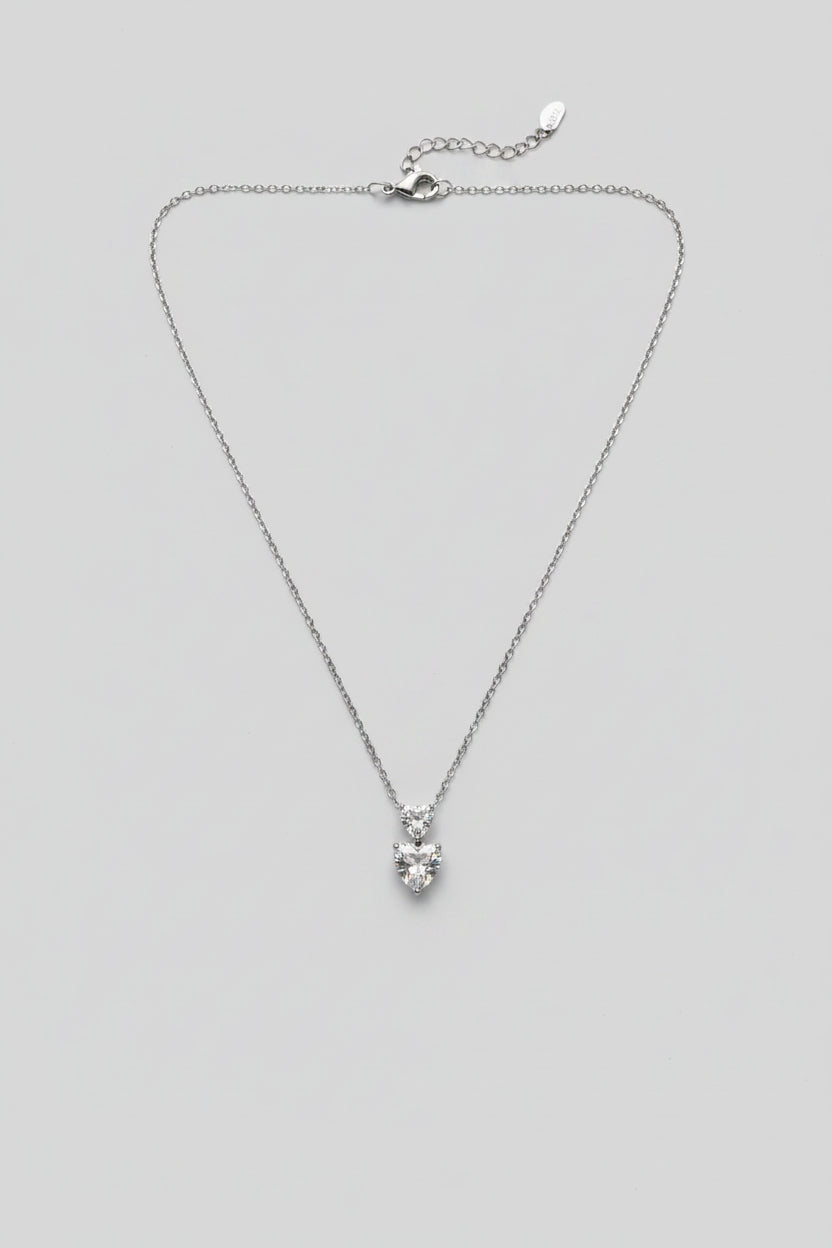 Duo Cordis — collana punto luce due cuori sovrapposti in acciaio argento